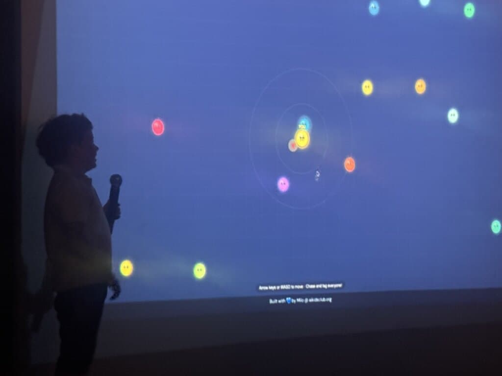 A Builder presenting Planet Painter with a microphone